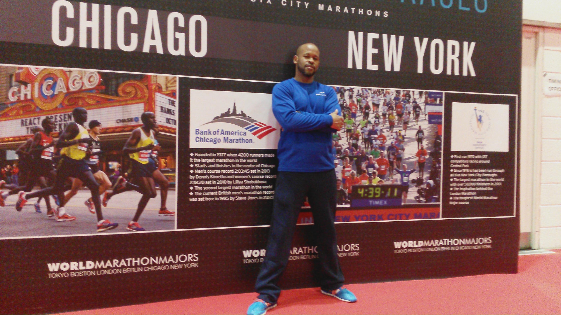 Gary Purdy standing in front of the World Marathon Majors Chicago and New York display board